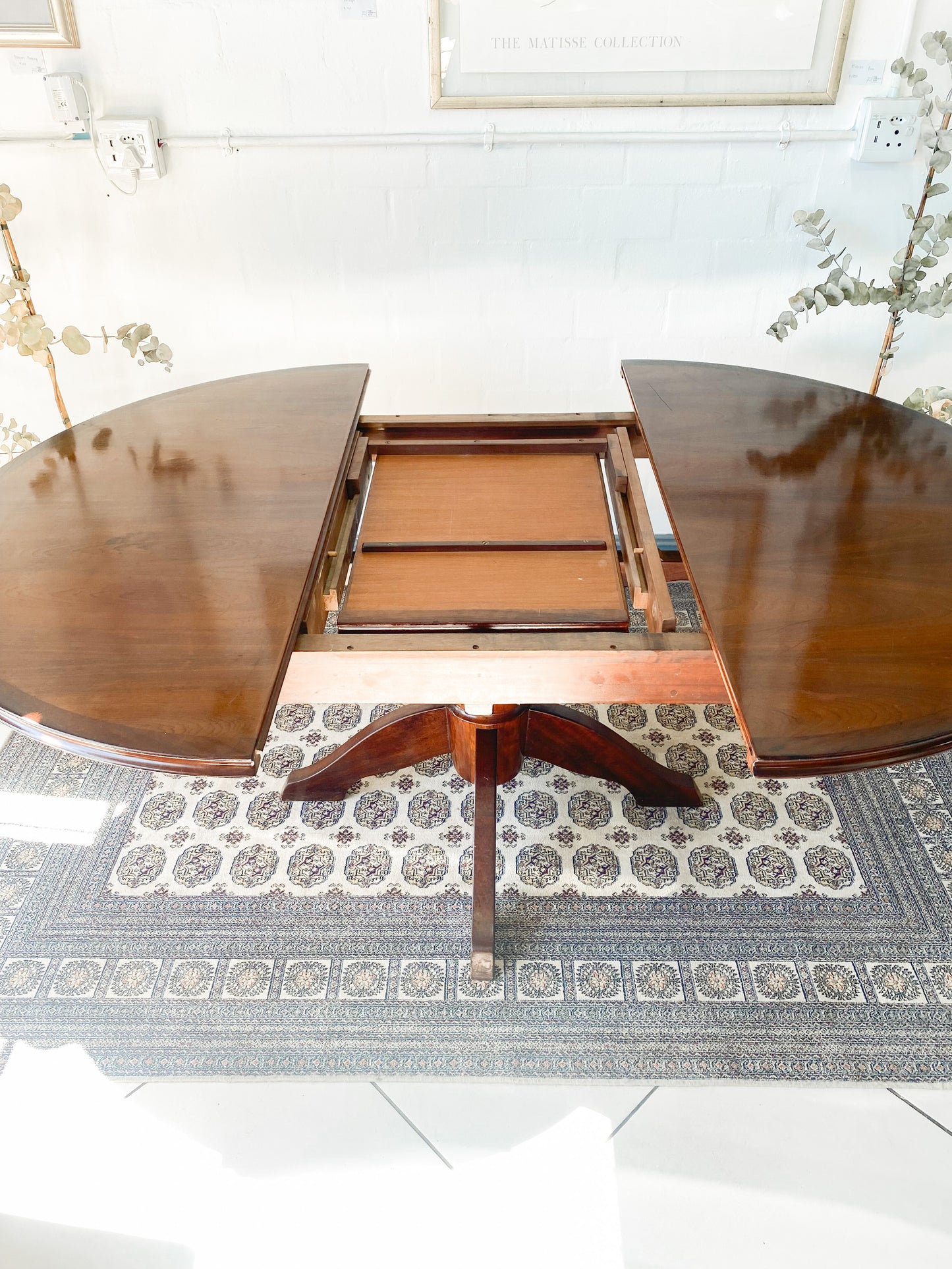 Elegant Extendable Imbuia 6-8 seat dining table made by premium South African designer EE Meyer.