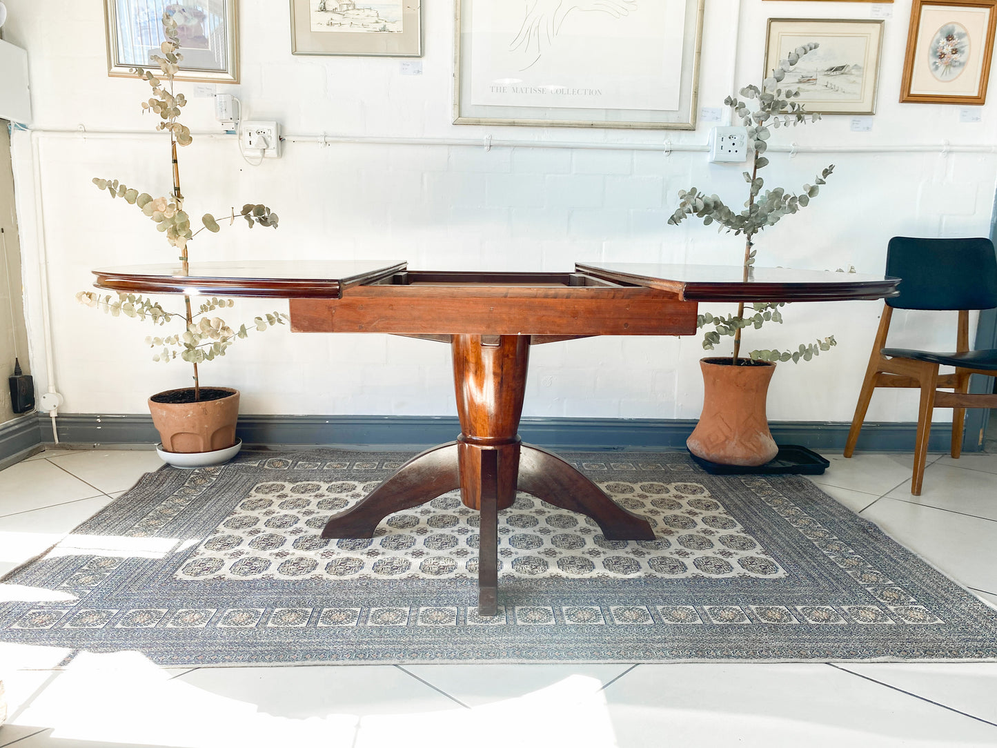 Elegant Extendable Imbuia 6-8 seat dining table made by premium South African designer EE Meyer.